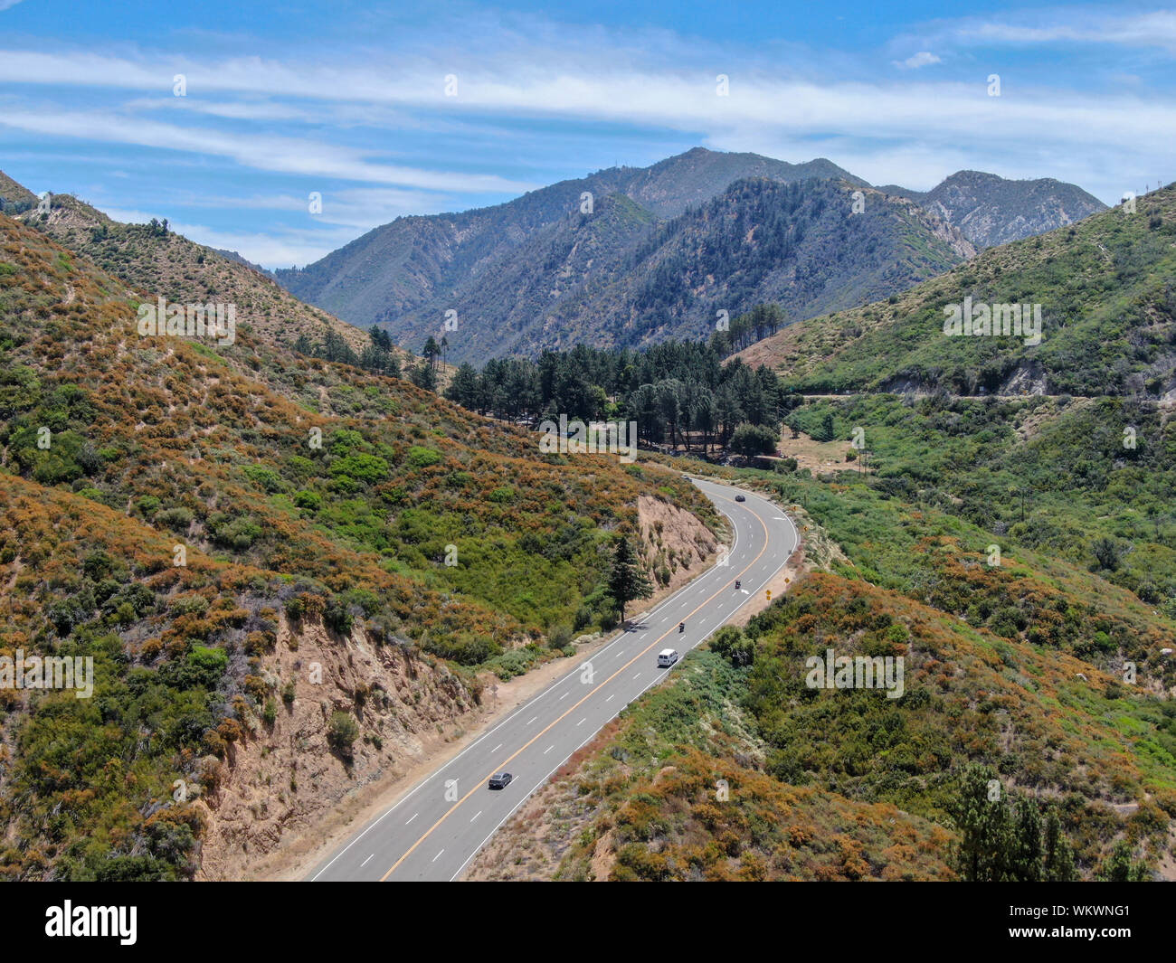 Asphalt road bends through Angeles National forests mountain ...