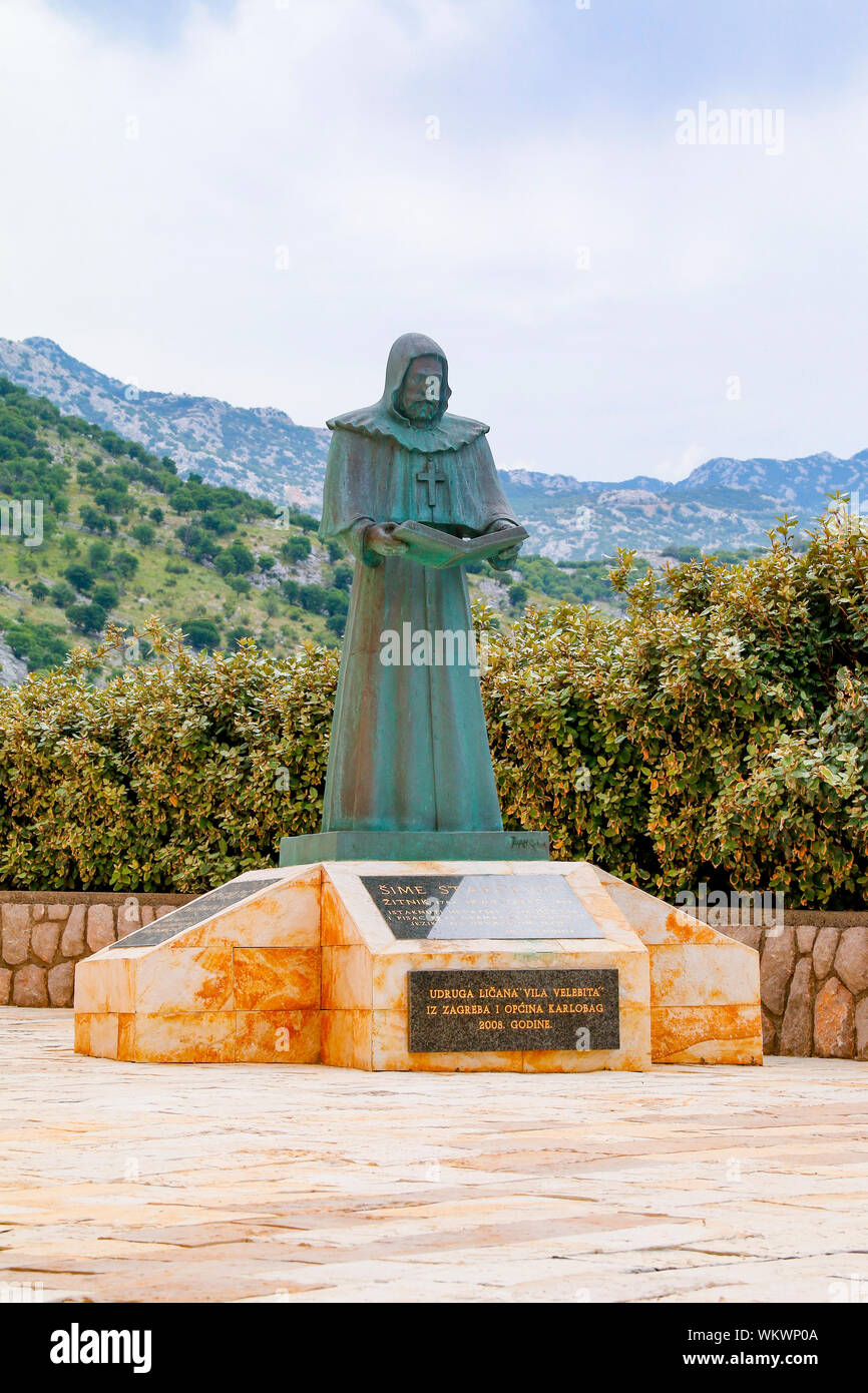 Statue of Sime Starcevic, a Croatian priest and linguist, outside the Church of St Karlo Boromejski in Karlobag, Croatia Stock Photo