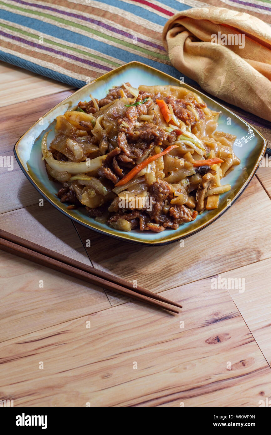 Stir fried Chinese beef chow fun with hor fun wide rice noodles cabbage