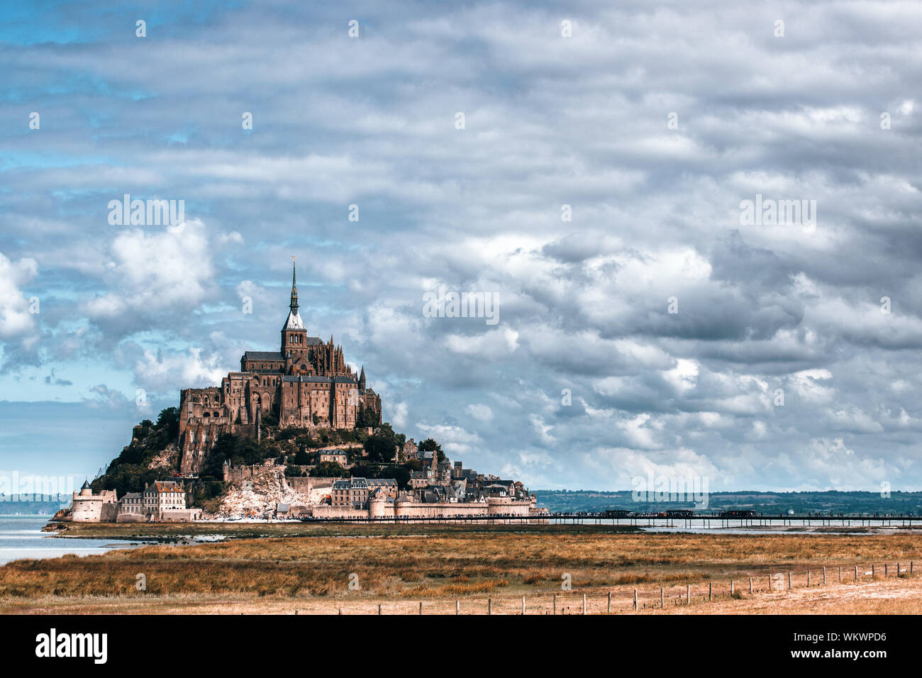 Scenic View Of Mont Saint-michel Against Cloudy Sky Stock Photo