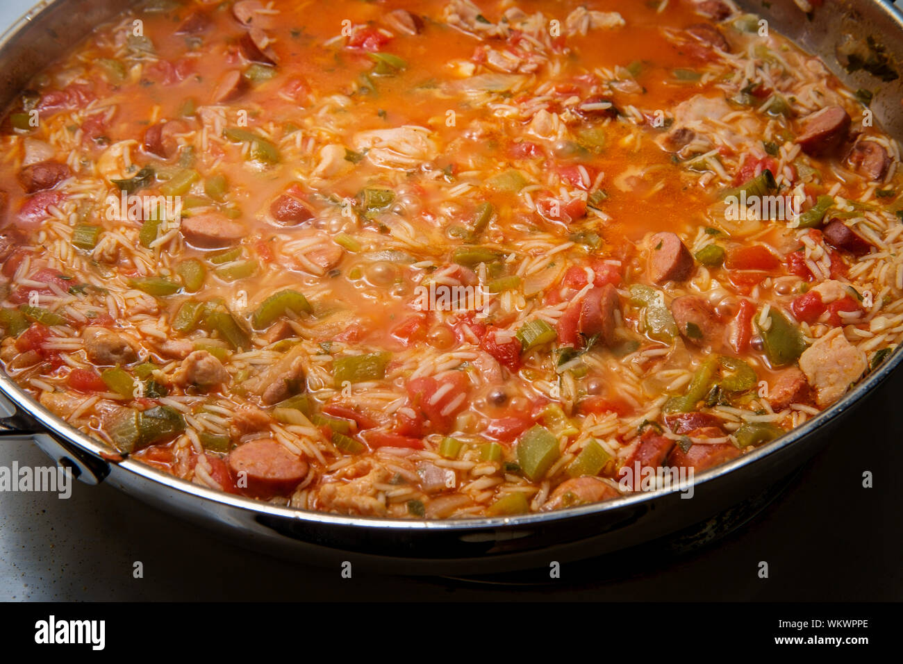 Cooking Creole pot of chicken and andouille sausage Jambalaya with rice Stock Photo Alamy