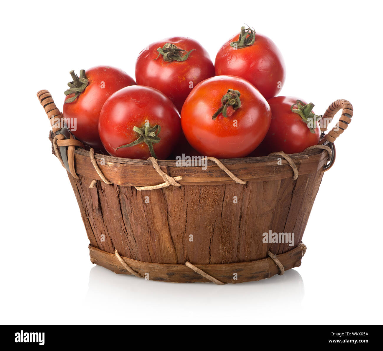 Red tomatoes in a basket isolated on white Stock Photo - Alamy