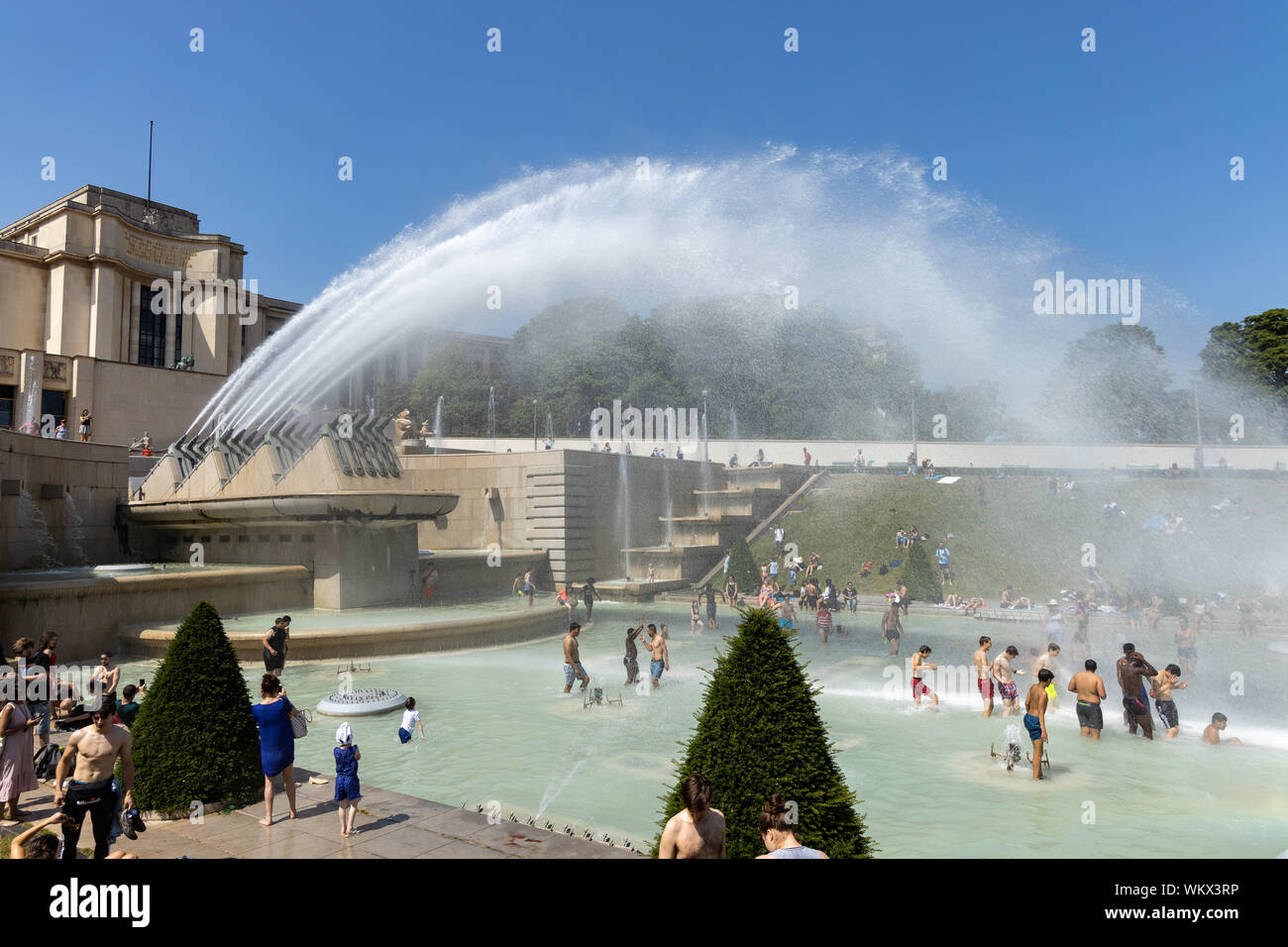 Paris, France, June 27, 2019: tourists and locals taking a bath in the Jardins du Trocad ro Guardians of the Trocadero under the powerful water Stock Photo