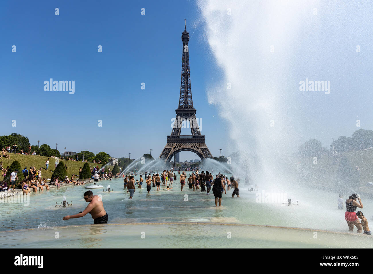 Paris, France, June 27, 2019: tourists and locals taking a bath in the Jardins du Trocad ro Guardians of the Trocadero under the powerful water Stock Photo
