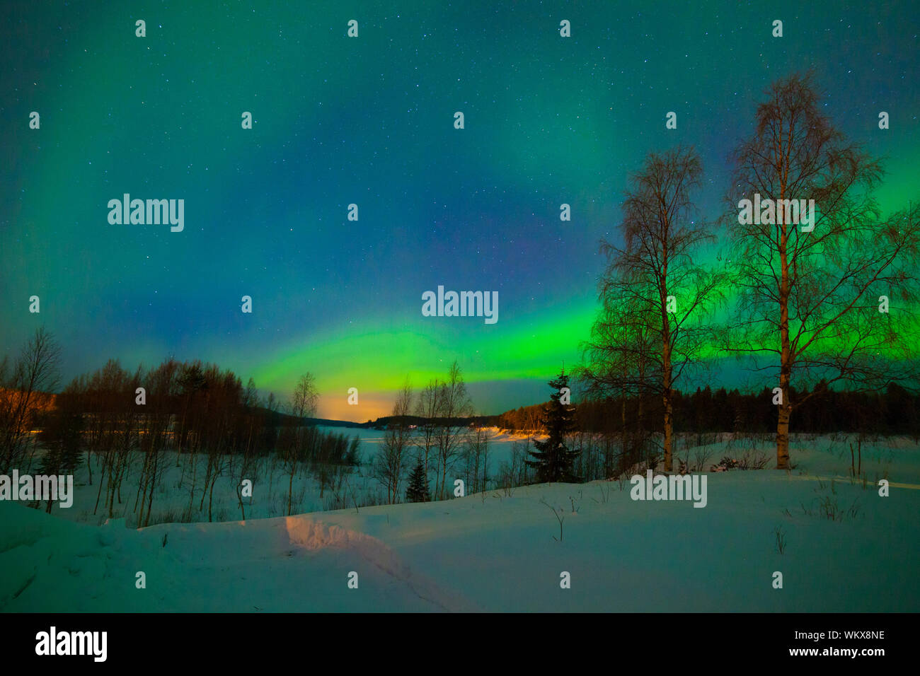 Intense northern lights - Aurora borealis over Lake in Finland Stock ...
