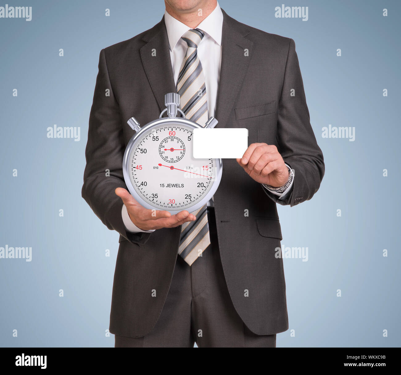 Businessman in suit hold empty card and stopwatch. Blue background ...
