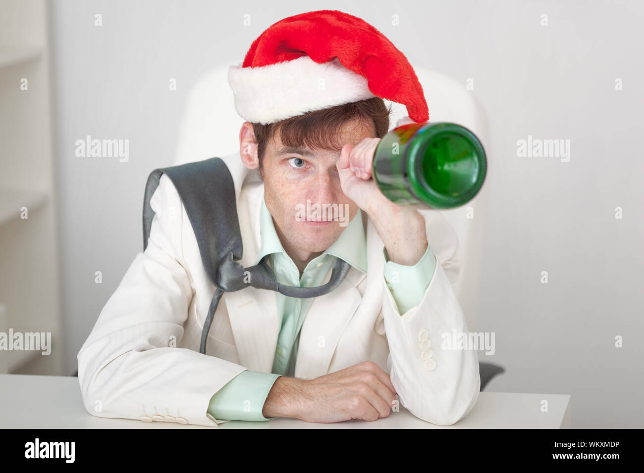 Am Using Guy The amusing guy in a Christmas cap with a bottle in a hand Stock Photo ...