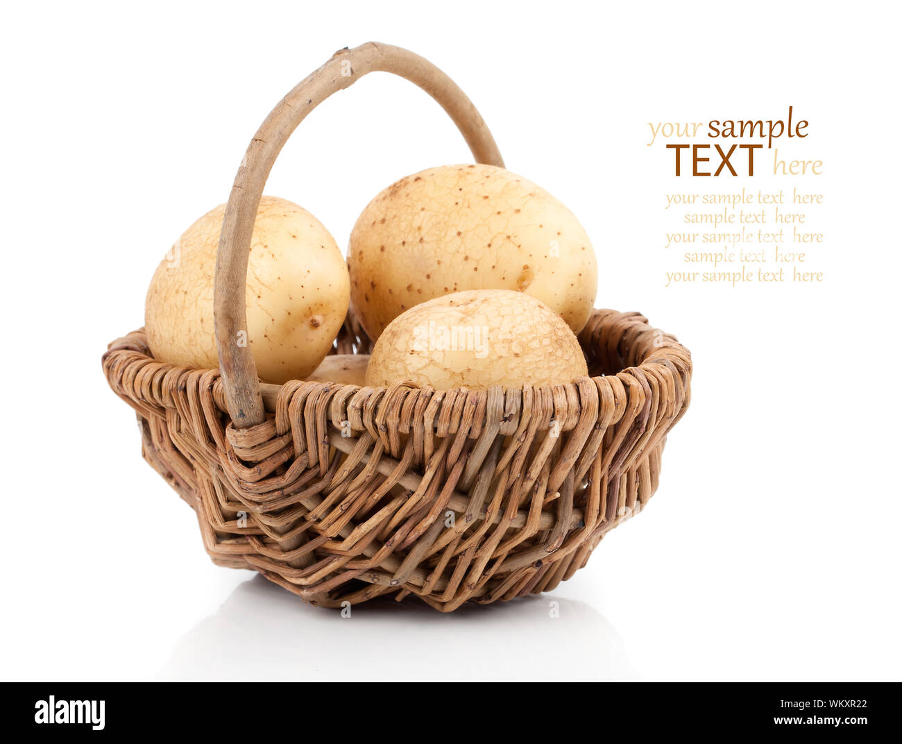 Golden Potatoes in wicker basket over white background Stock Photo