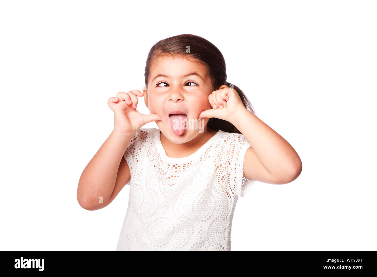 Cute girl making funny face sticking tongue out and crossed eyes