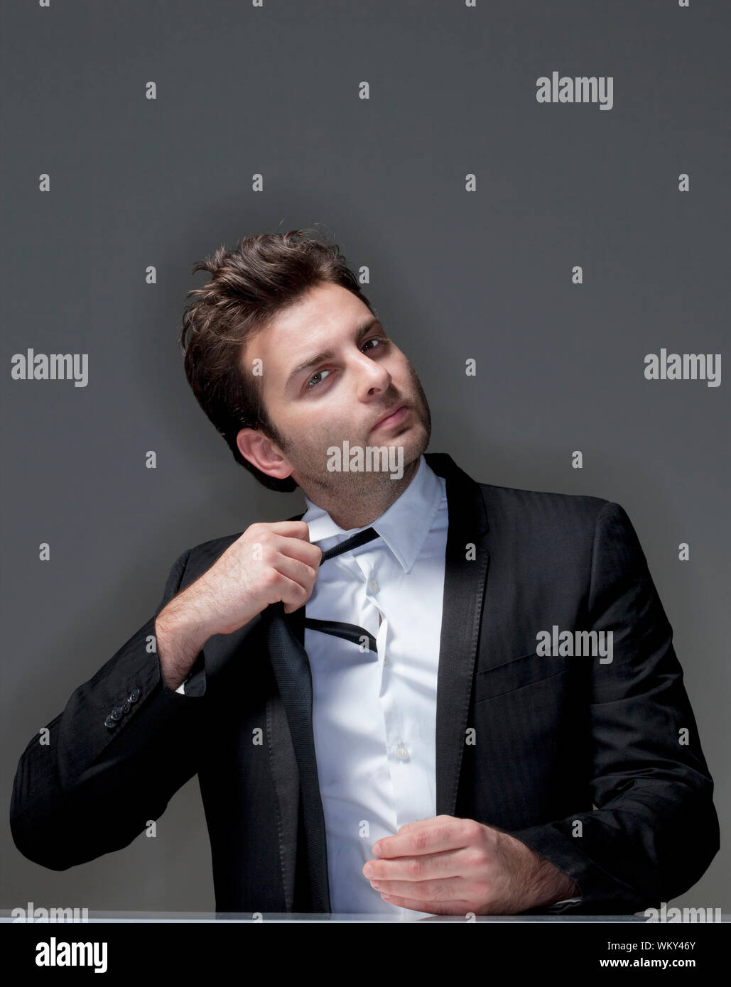 Man loosening tie hi-res stock photography and images - Alamy