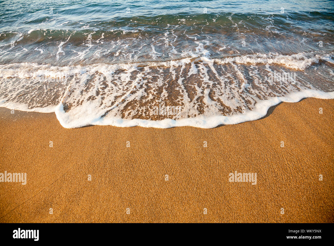 Washing Wave Wave washing up onto a sea shore in the evening light Stock Photo - Alamy