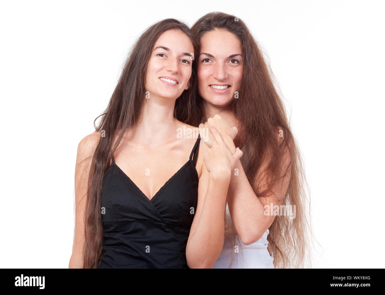 two-sisters-with-very-long-brown-hair-standing-smiling-isolated-on