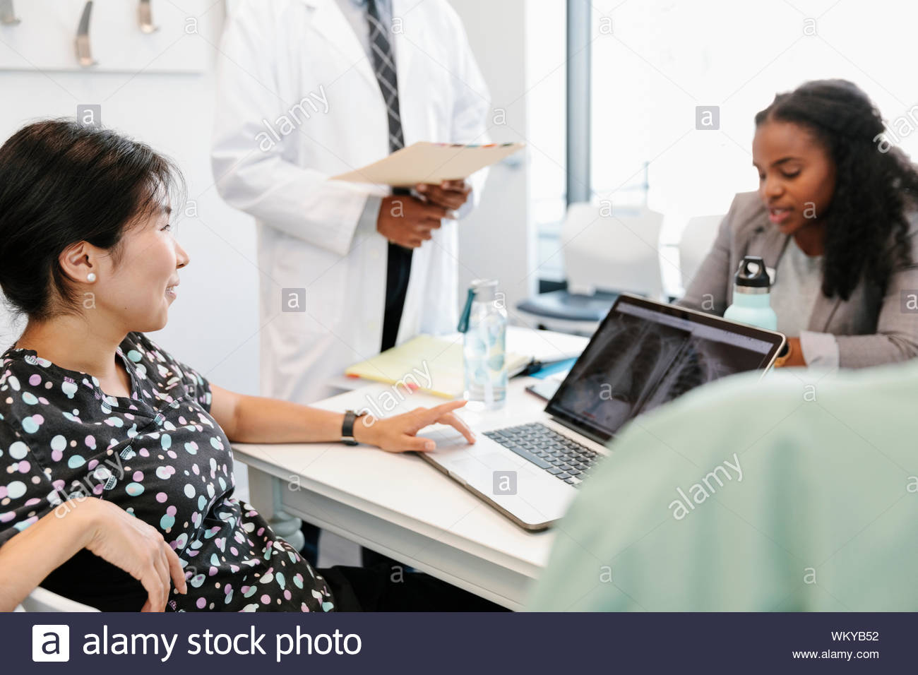 Nurse meeting with doctors and administrator in clinic Stock Photo
