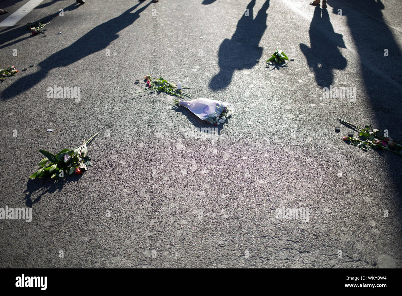 Shadow Of People With Bouquets On Street After Terrorist Attack Stock Photo