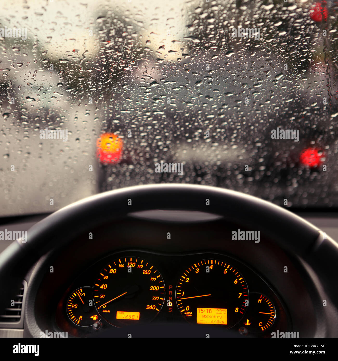dashboard and rain droplets on car windshield Stock Photo