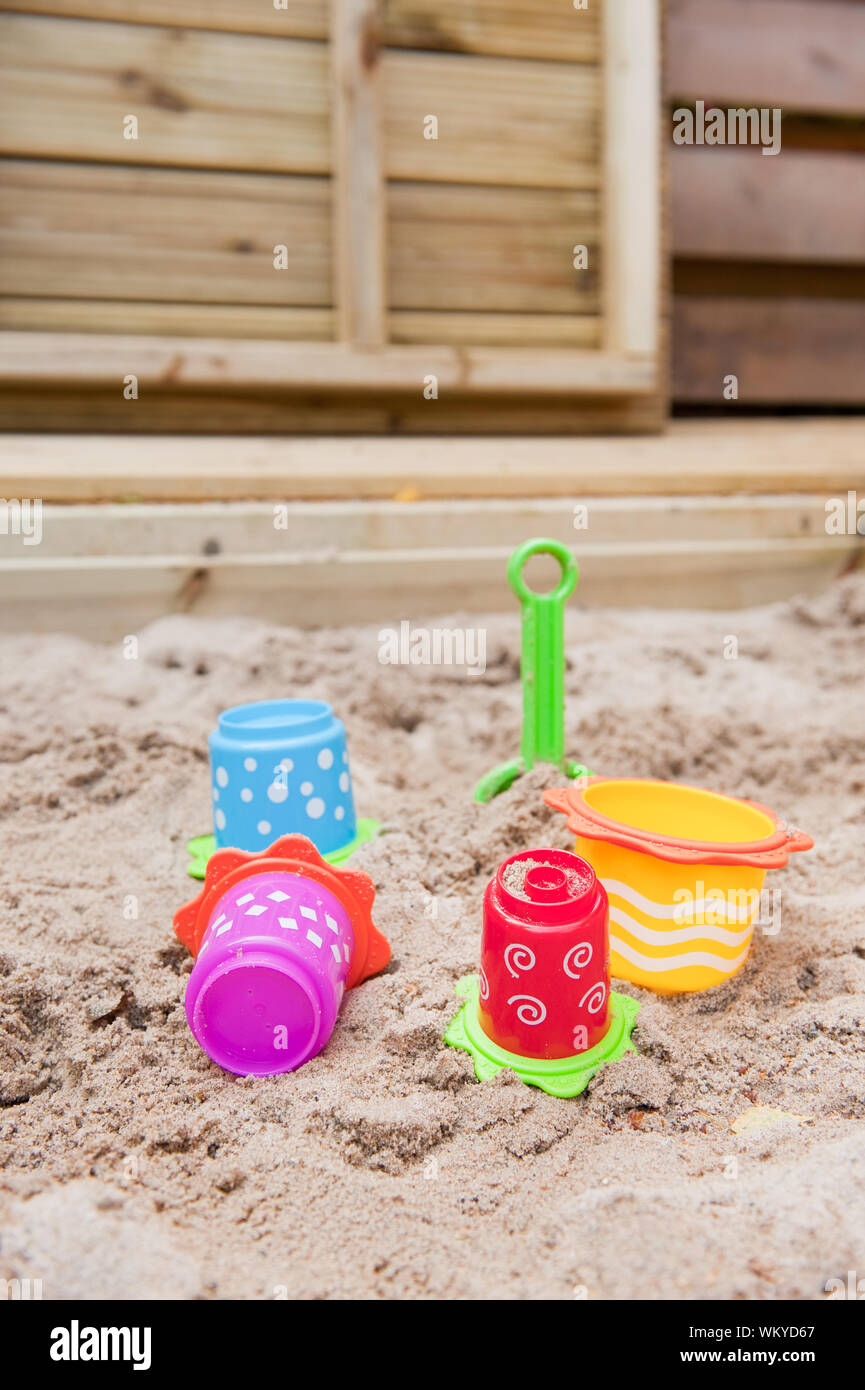 Plastic colorful toys in the sand box to play with Stock Photo Alamy