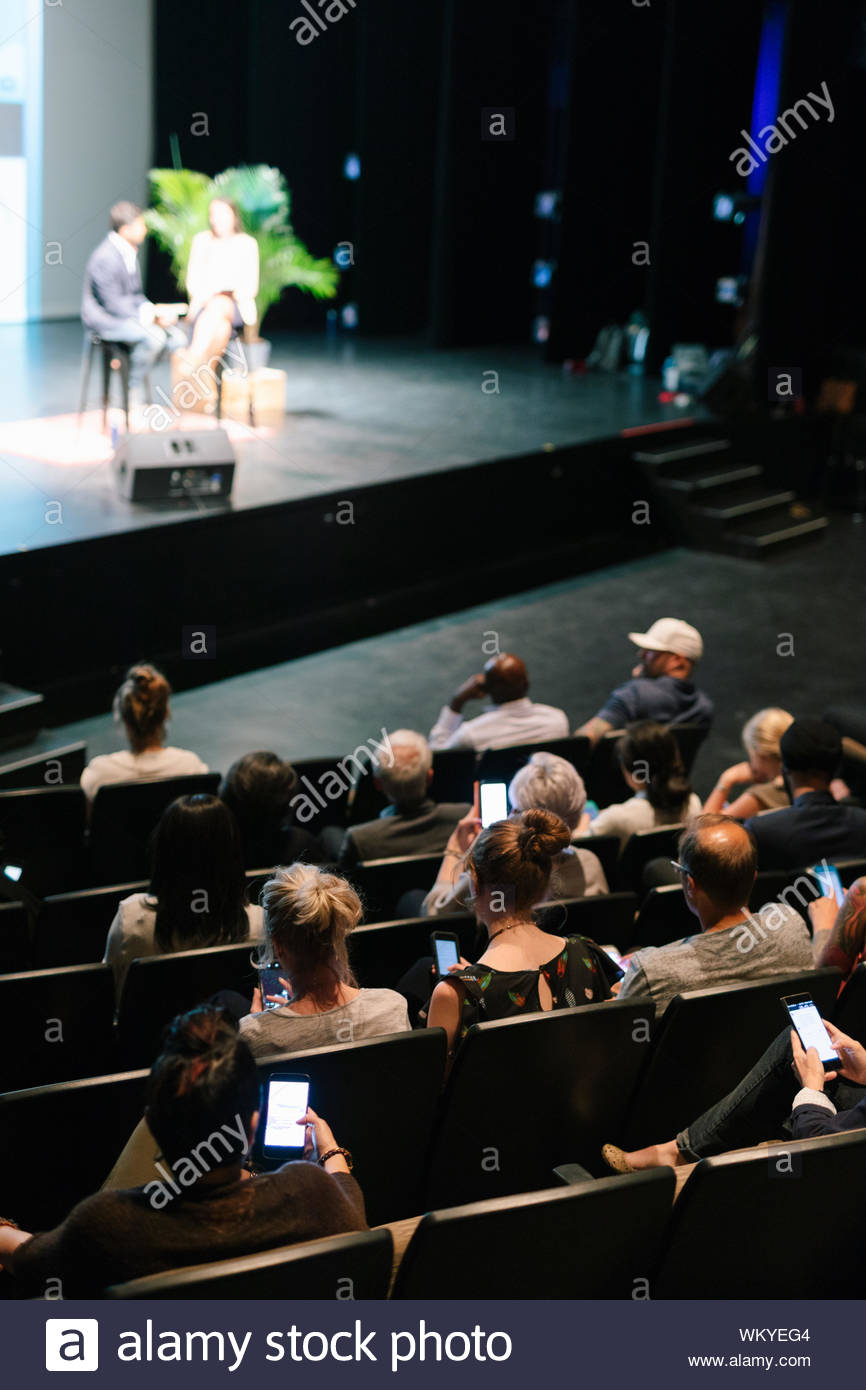 Audience with smart phones at presentation Stock Photo