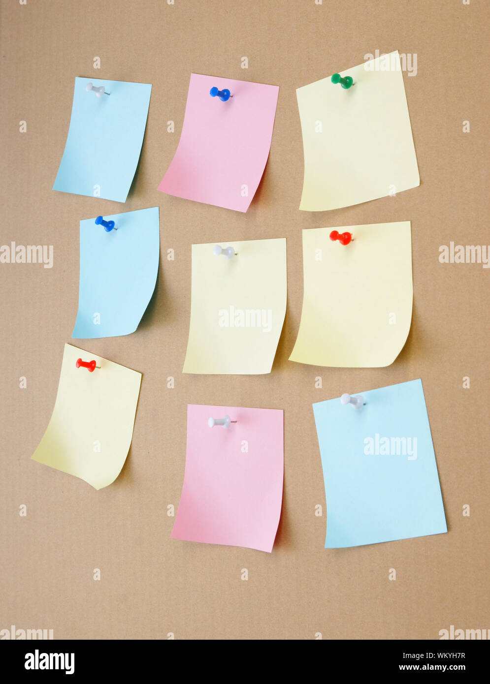 leaflets with advertisements pinned on the bulletin board Stock Photo