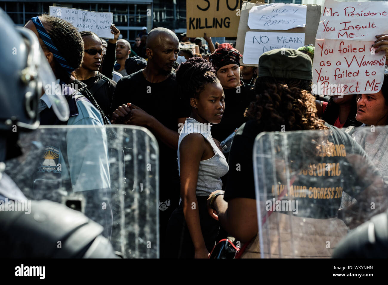 Police block the entrance to the Cape Town World Economic Forum from gender activists protesting South Africa's high levels of sexual violence Stock Photo