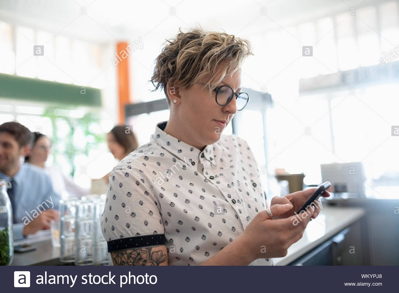 Small business owner using cell phone in restaurant Stock Photo