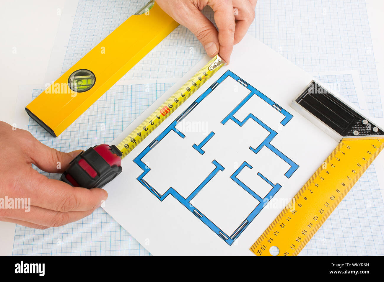 drawing at home with construction tools on a background of graph paper ...