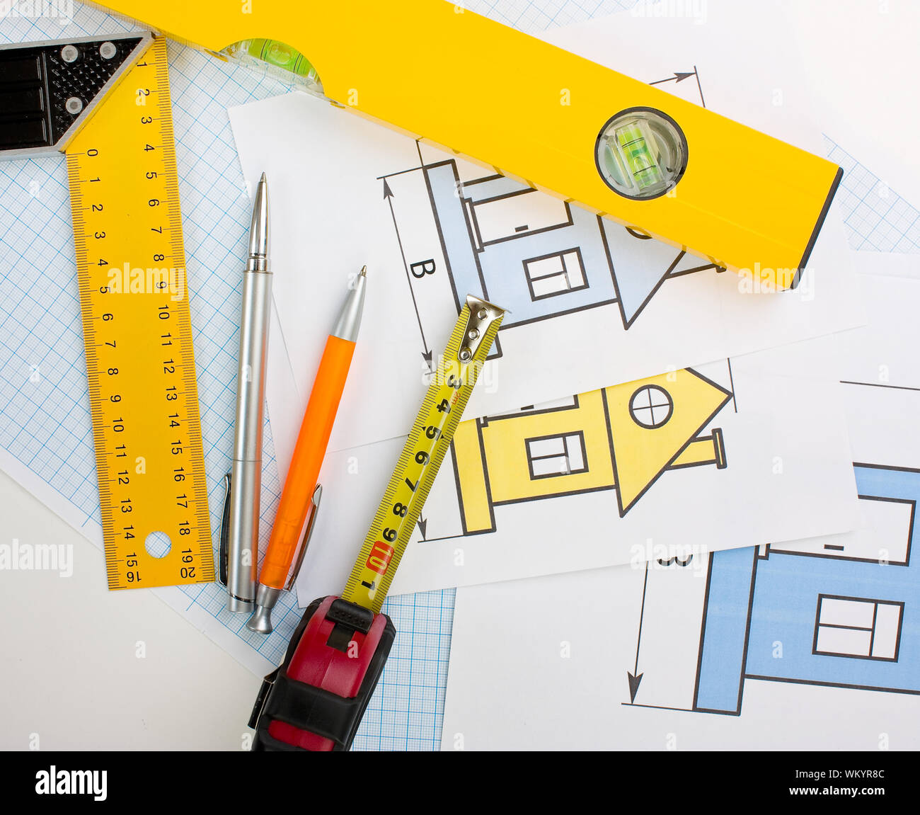 drawing at home with construction tools on a background of graph paper ...