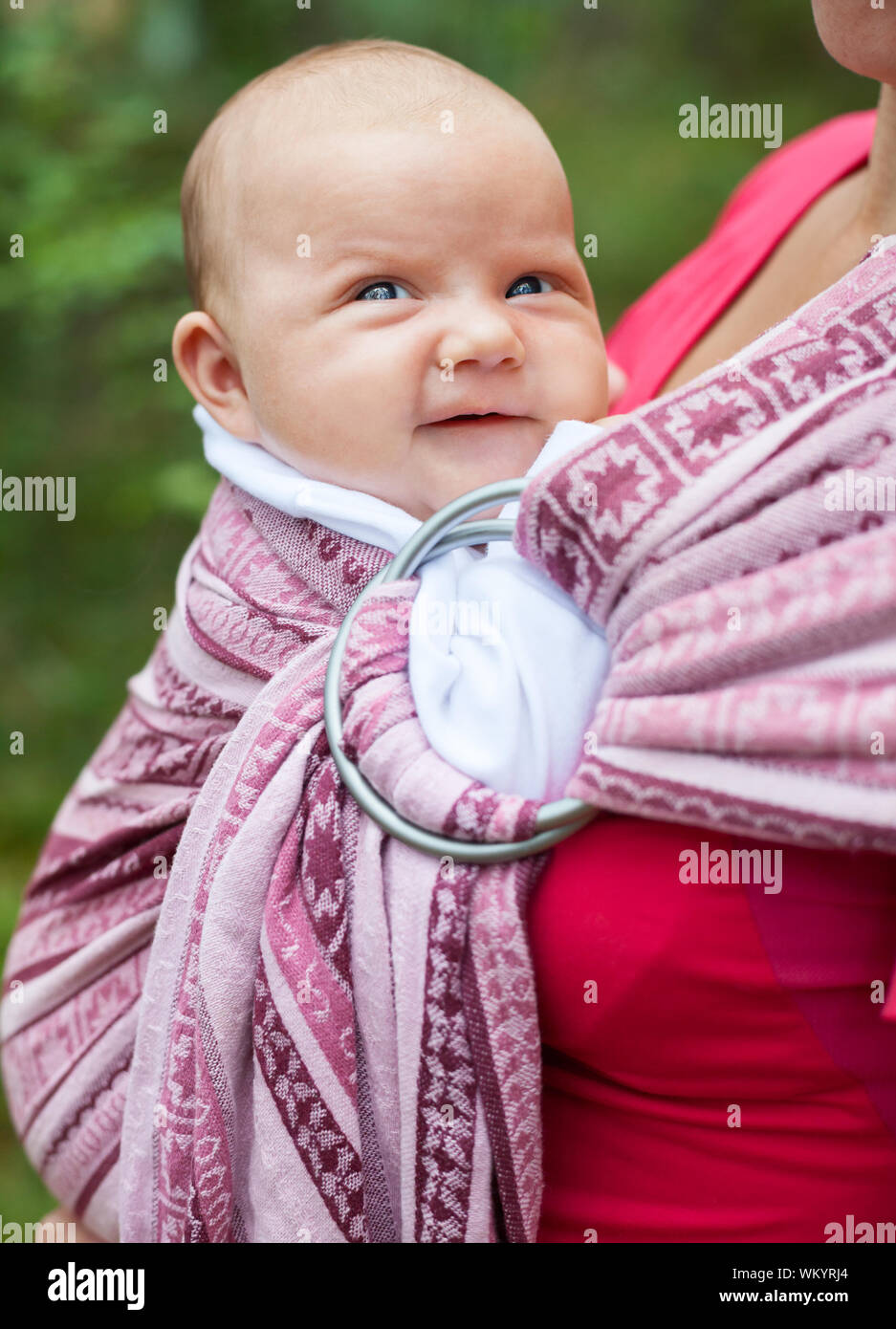Mother carrying her child in a baby sling Stock Photo Alamy