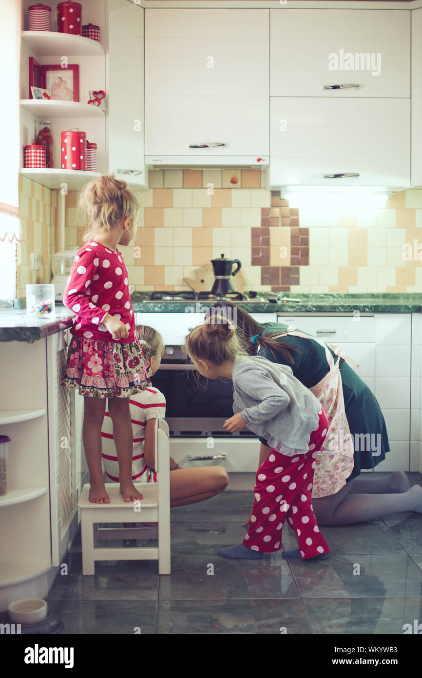 Mother With Three Kids Cooking Holiday Pie In The Kitchen Casual