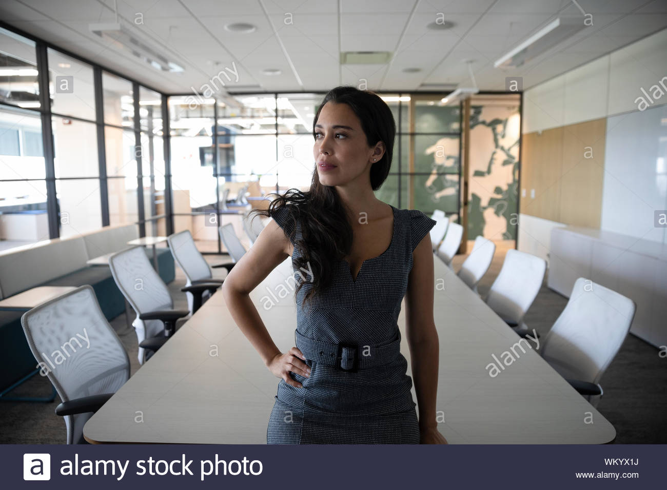 Portrait of businesswoman in office with hand on hip Stock Photo