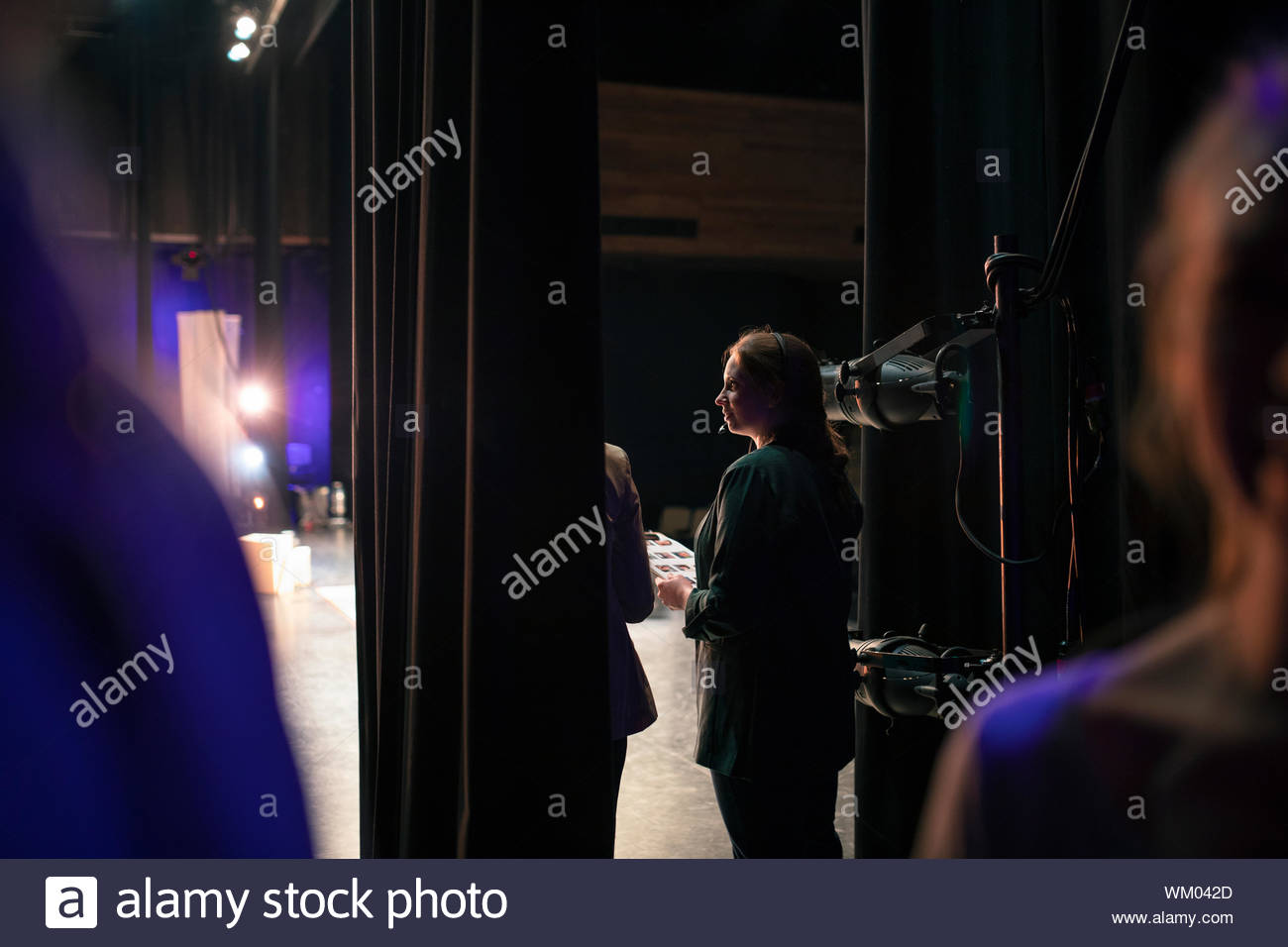 Female event coordinator with clipboard backstage Stock Photo Alamy