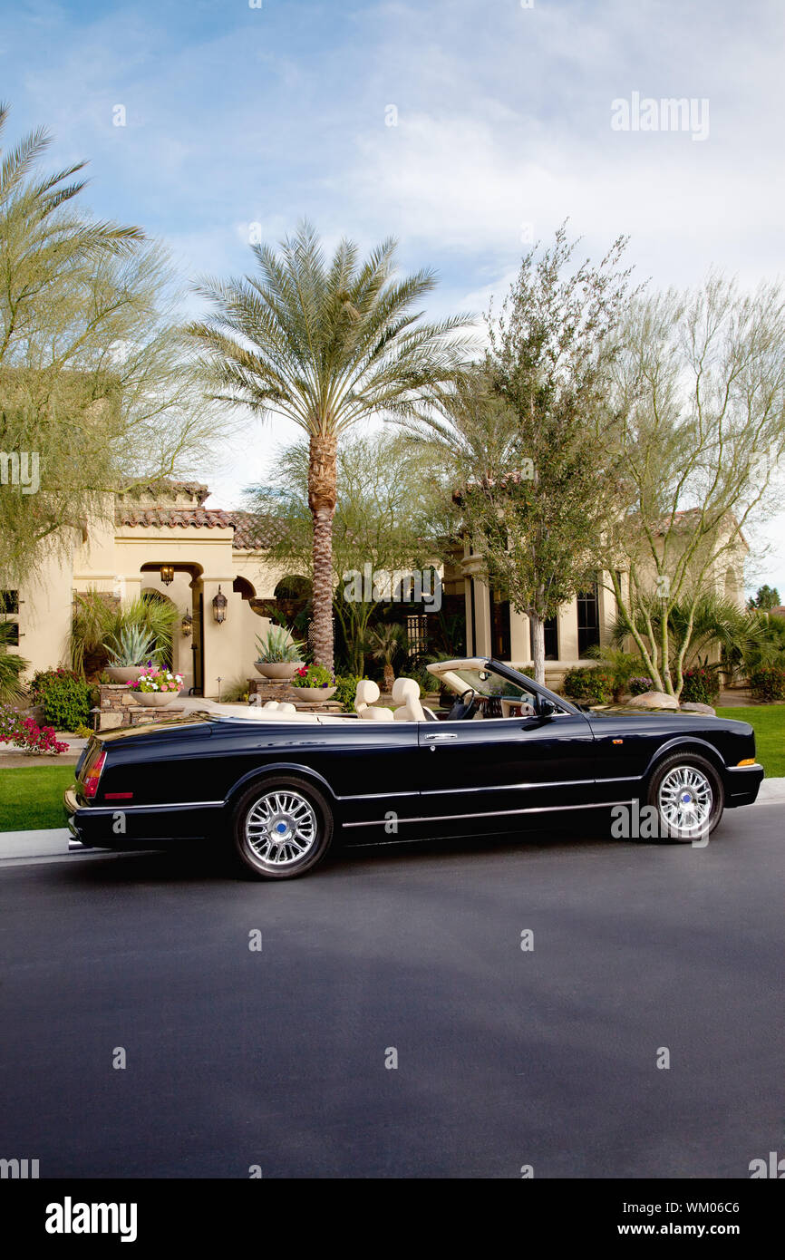 Luxurious open roof car parked outside villa Stock Photo Alamy