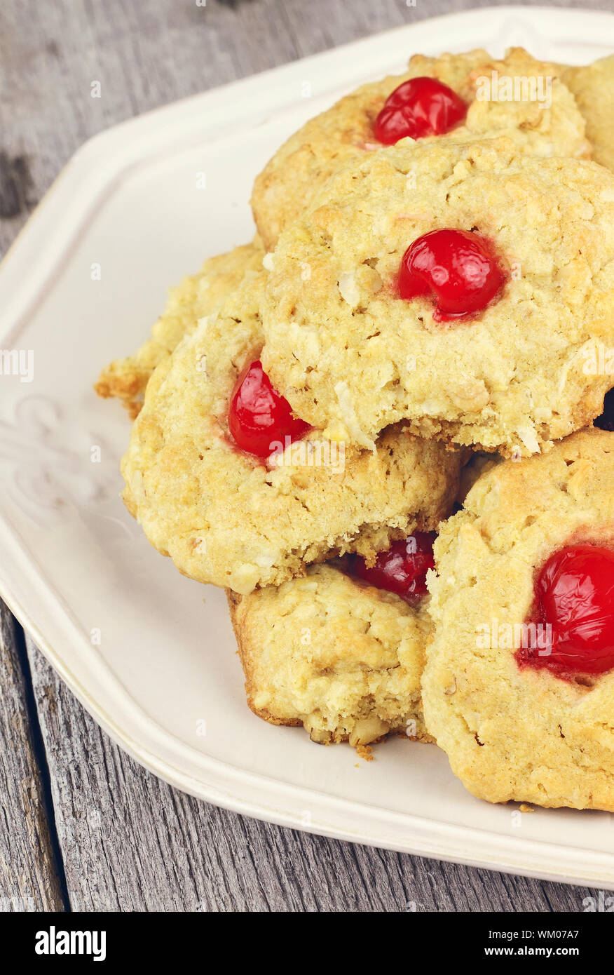 Bachelor Buttons cookies. Delicious cookies with a cherry center on a rustic background. Shallow DOF. Stock Photo