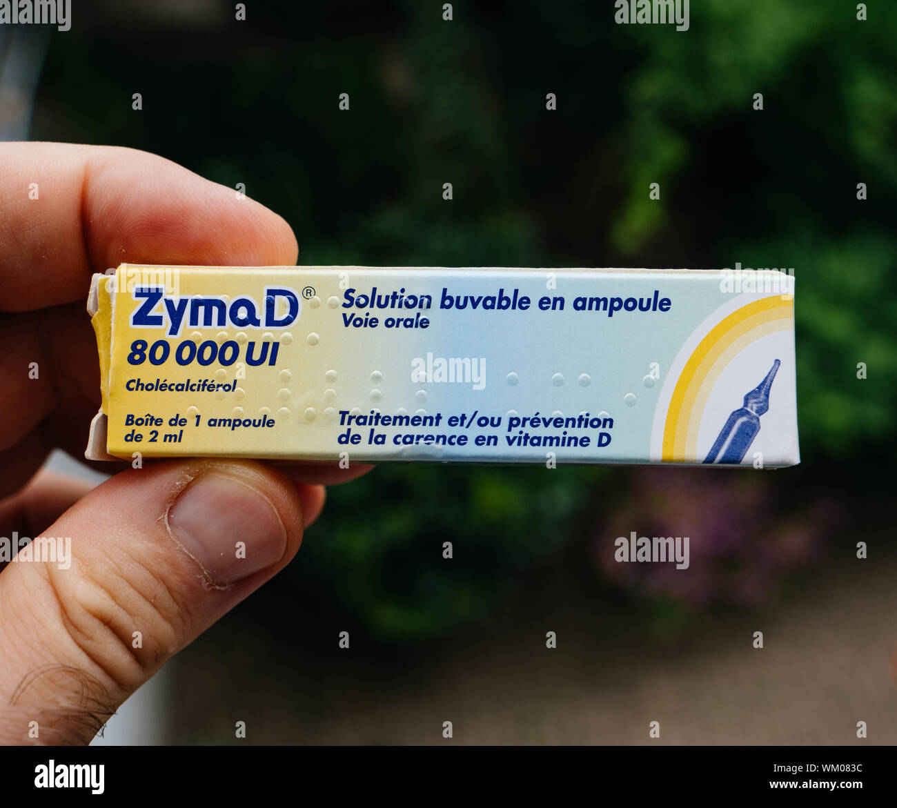Paris, France - Aug 20, 2019: Man hand holding ZymaD 80000 UI  Cholecalciferol prevention of lack for Vitamin D Stock Photo - Alamy