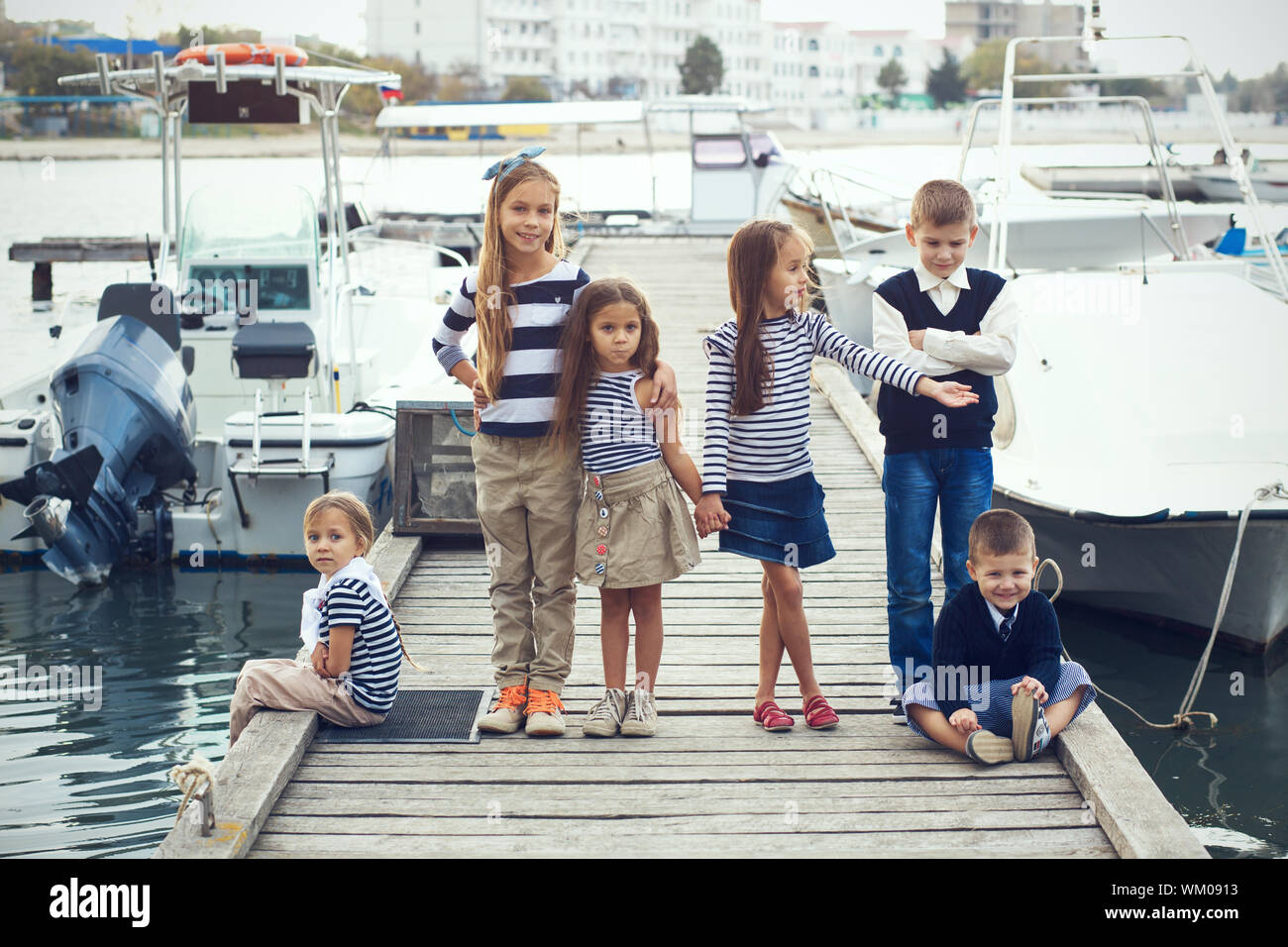 Group of 6 fashion kids wearing navy clothes in marine style walking in the  sea port Stock Photo - Alamy