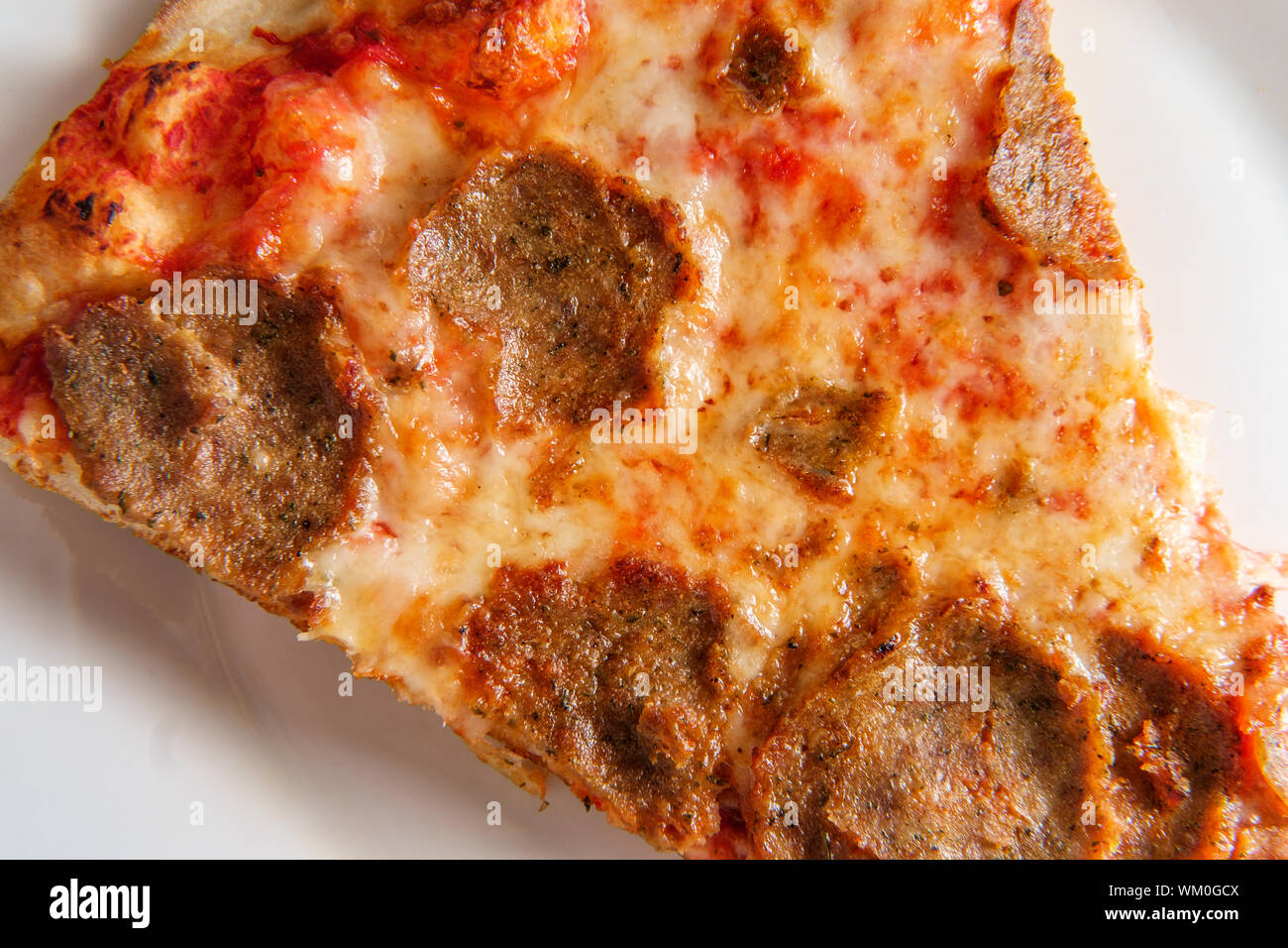 New York style slice of pizza with sliced meatball topping Stock Photo