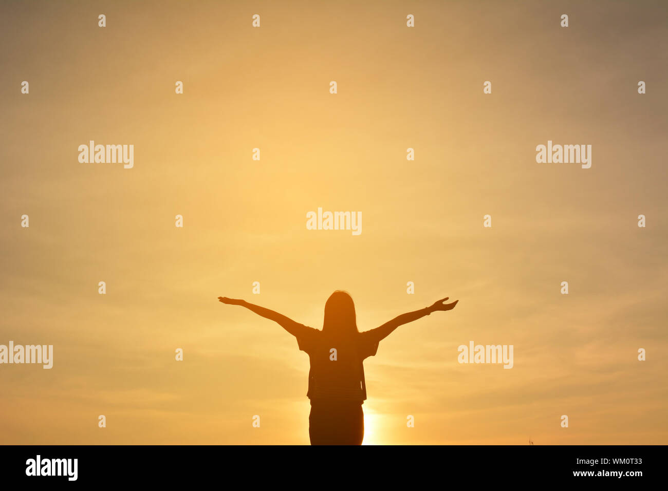 Woman arms outstretched sunset hi-res stock photography and images - Alamy