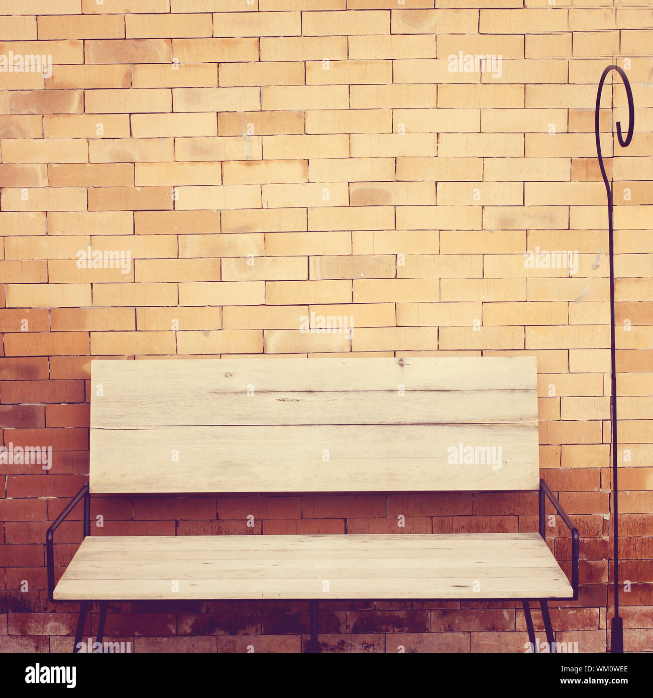 Outdoor Wooden Chair On Brick Wall Retro Filter Effect