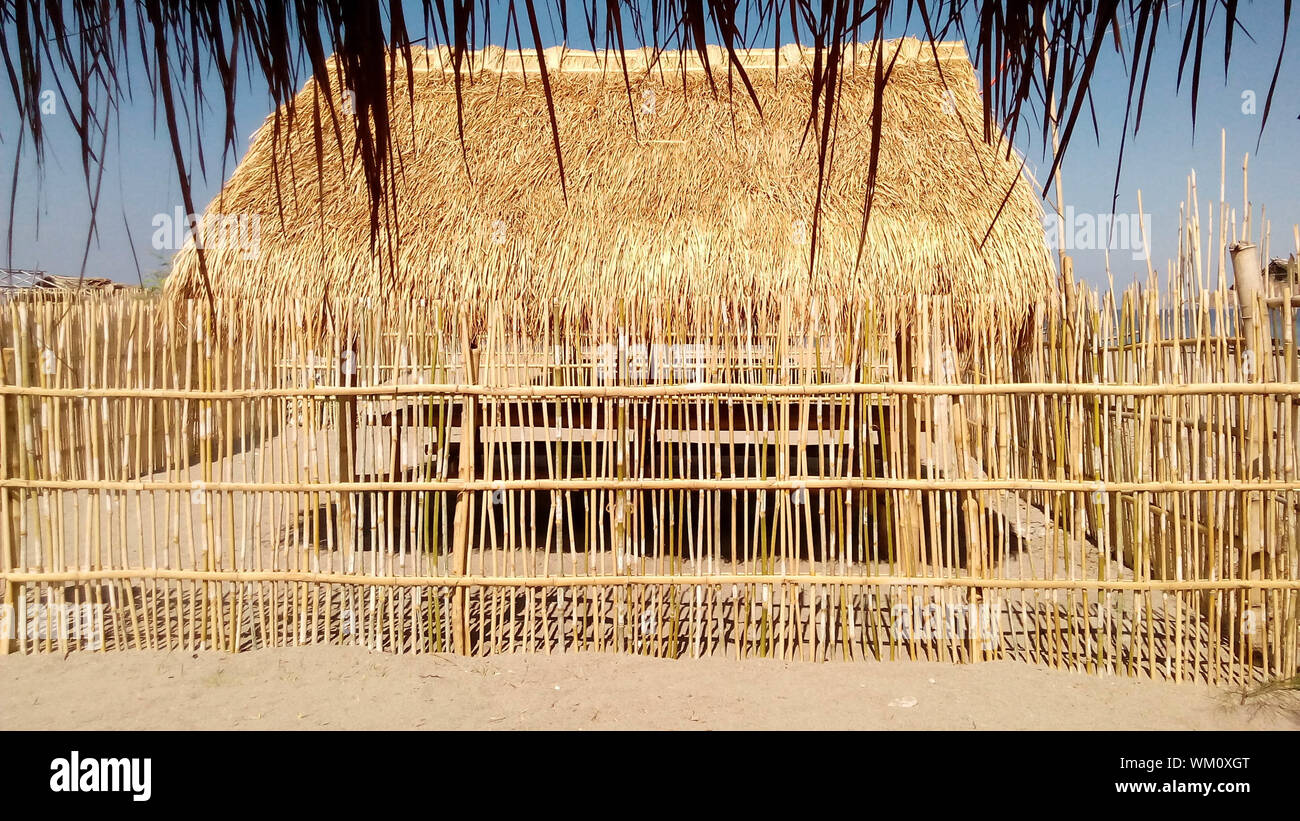 Nipa hut with bamboo fence near the beach.  summer and travel concept. Stock Photo