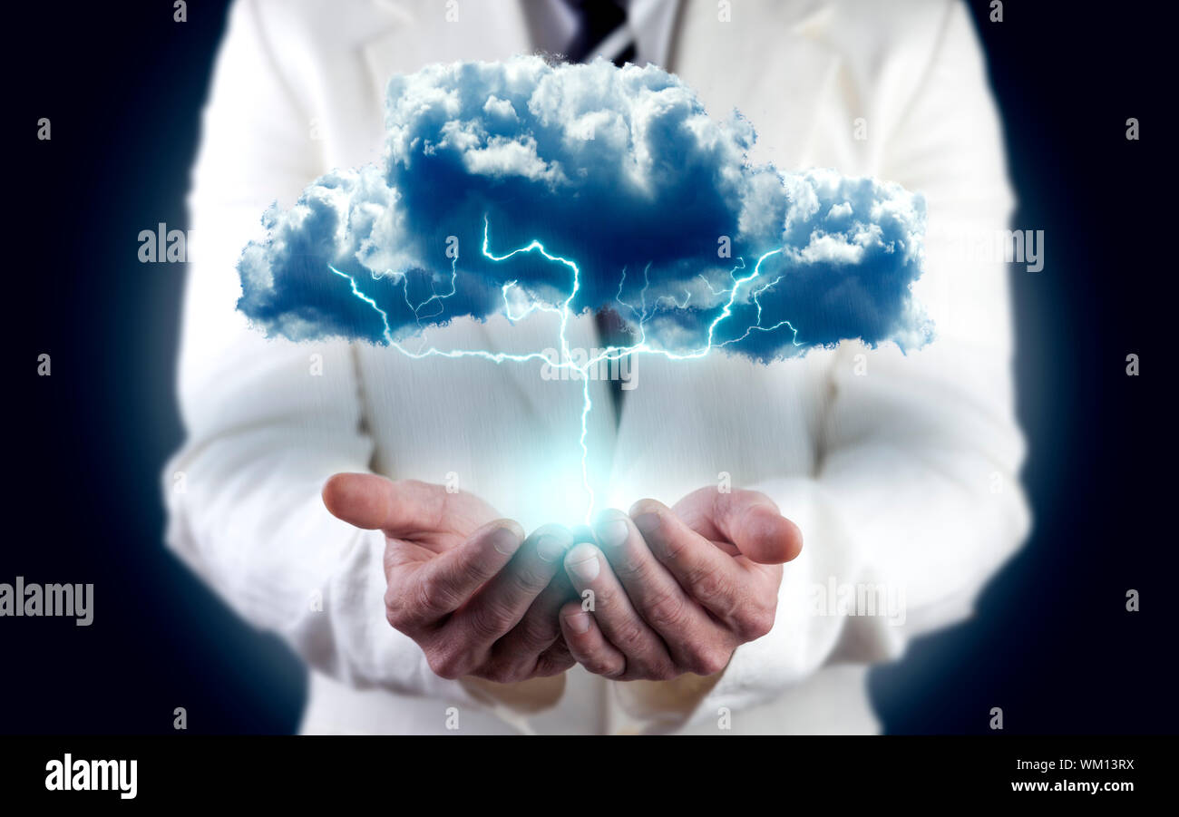 concept of energy and electricity. Businessman holding cloud with ...