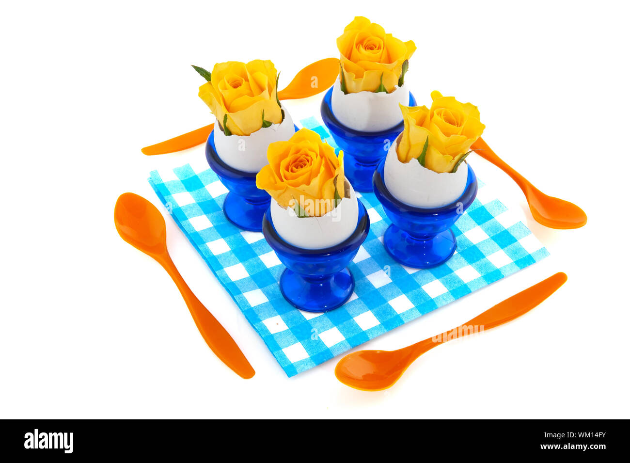 Easter flowers in egg cups with plastic spoons Stock Photo
