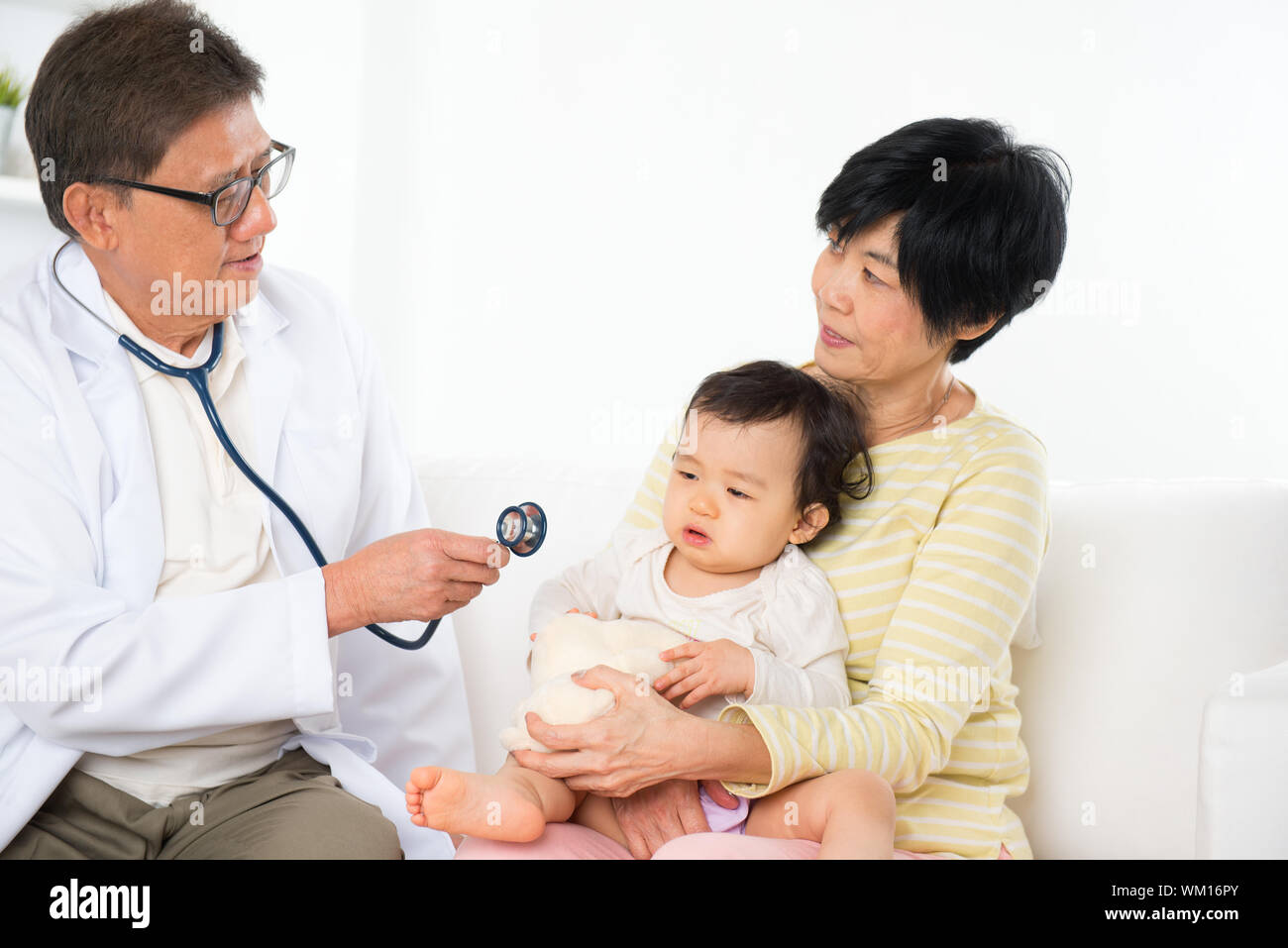 Family doctor examining baby girl. Pediatrician and patient. Stock Photo