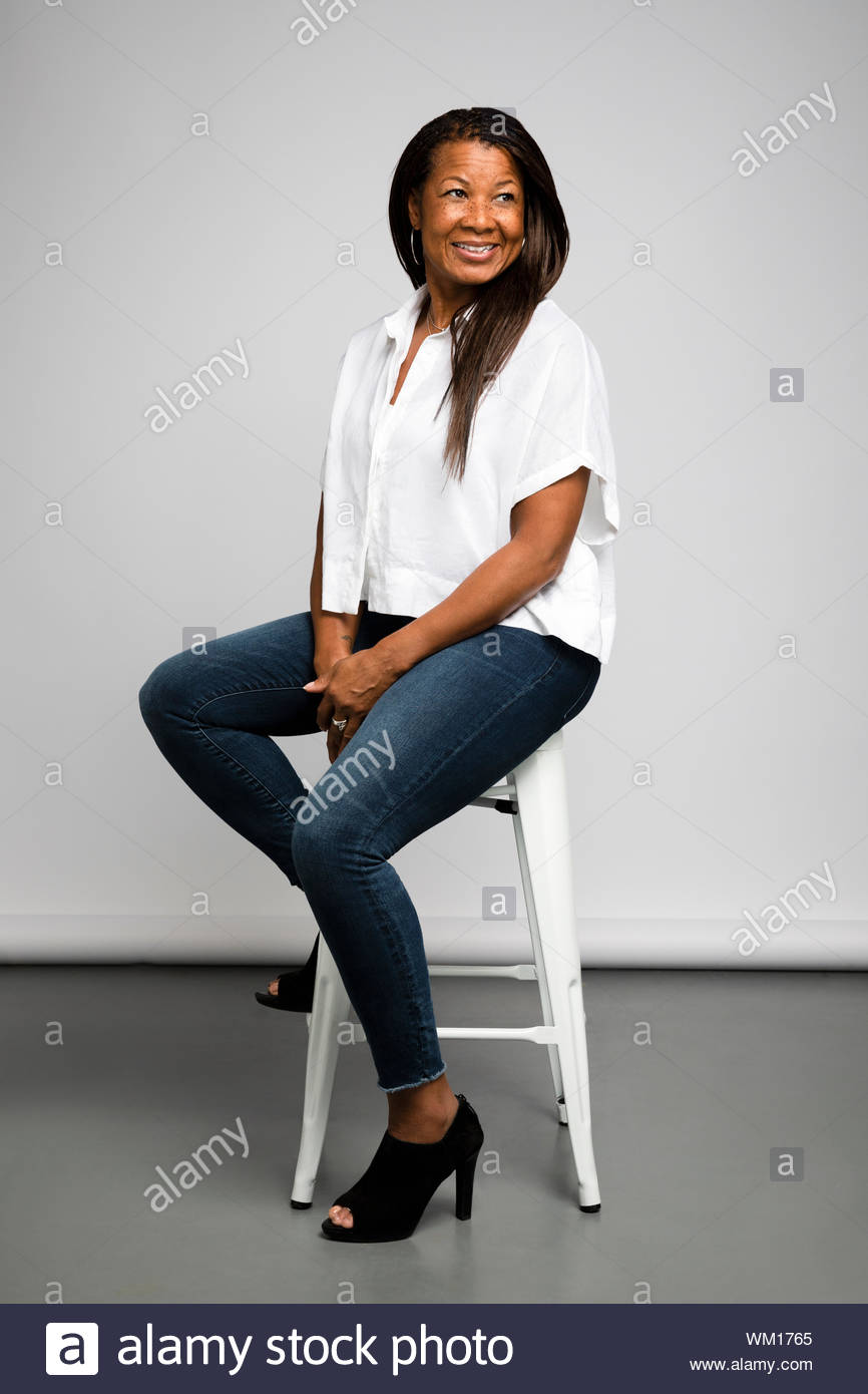 Black woman sitting on stool hi-res stock photography and images - Alamy
