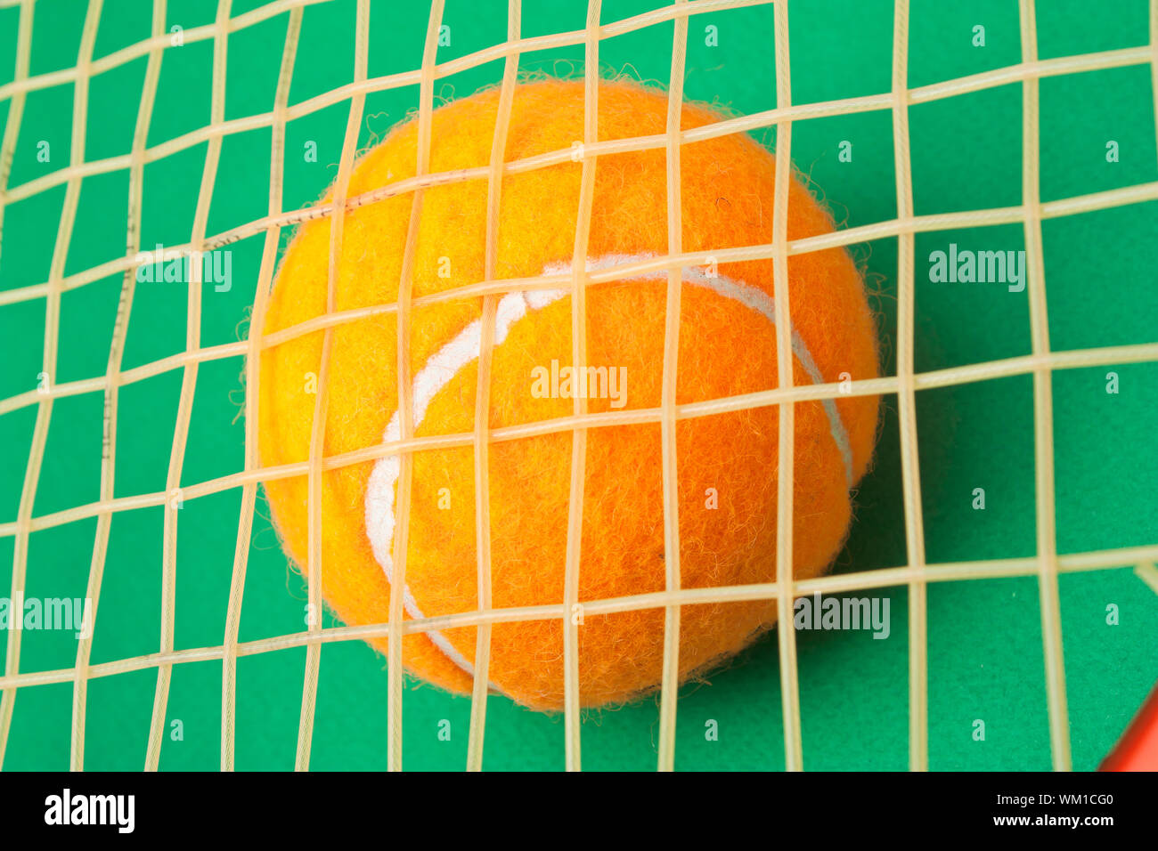 tennis racket and a ball on a green background Stock Photo - Alamy