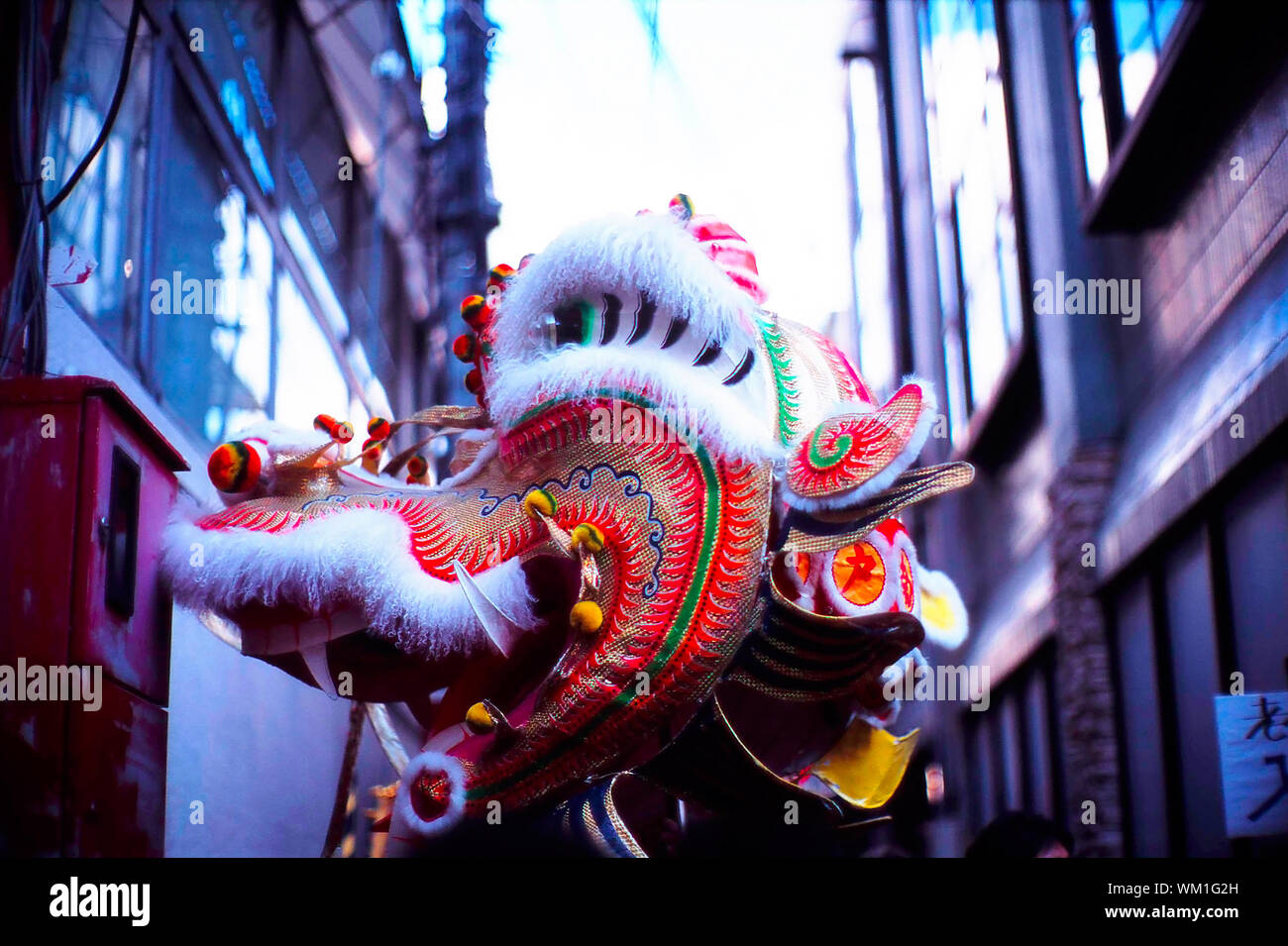 Chinese Dragon Amidst Buildings In City At Lunar New Year Stock Photo
