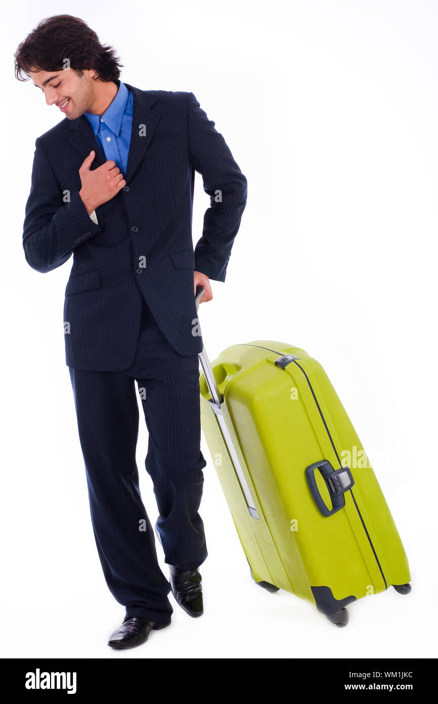 Corporate man looking down with is luggage on isolated white backround Stock Photo