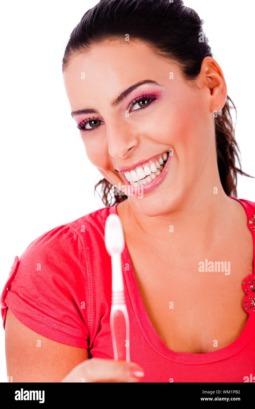 beautiful young woman holding tooth brush and smiling in isolated white backround Stock Photo