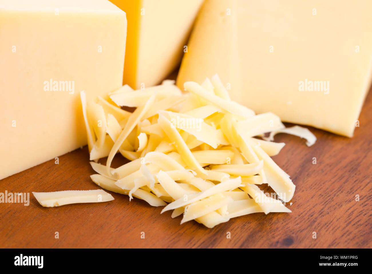 Grated cheddar cheese with block hi-res stock photography and images ...
