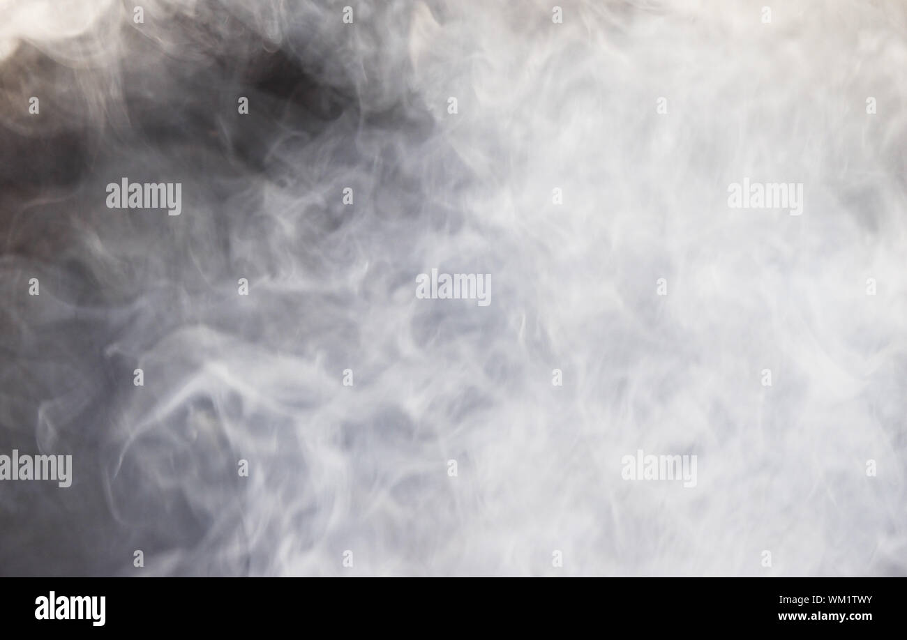 Blurry white mist or smoke or steam on black background, Pollution and burning Stock Photo