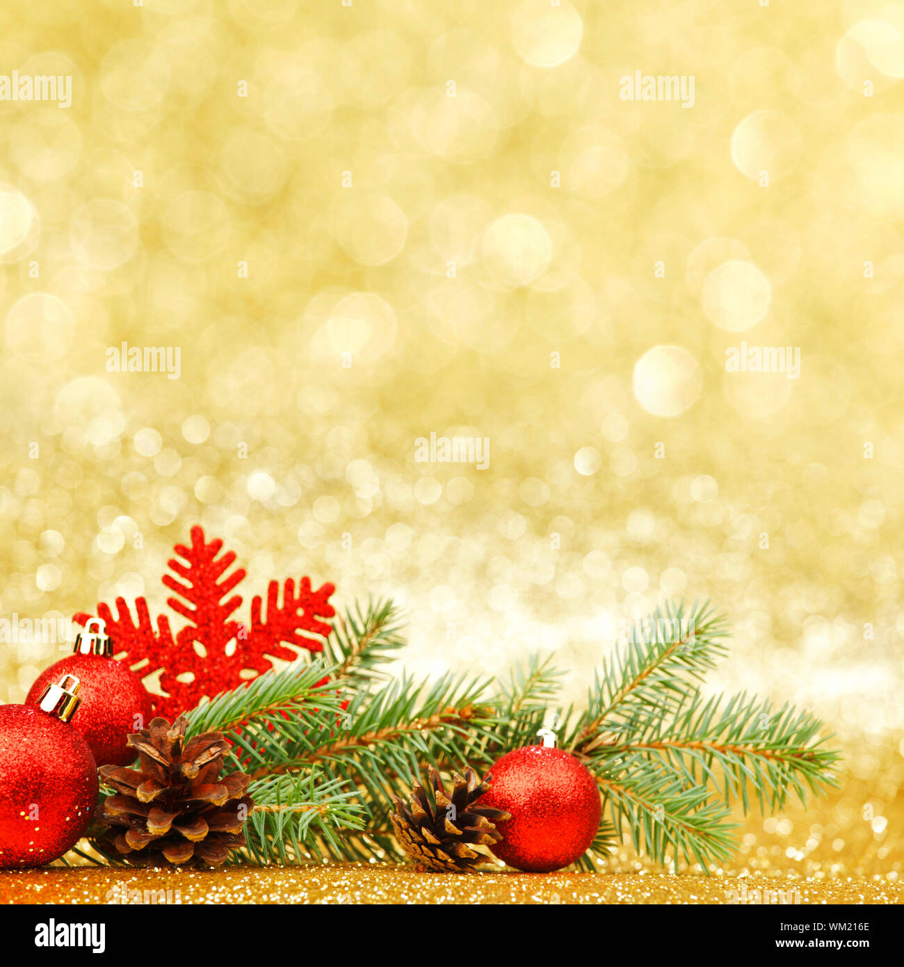 Christmas card with fir branch and decorations on golden gitter ...