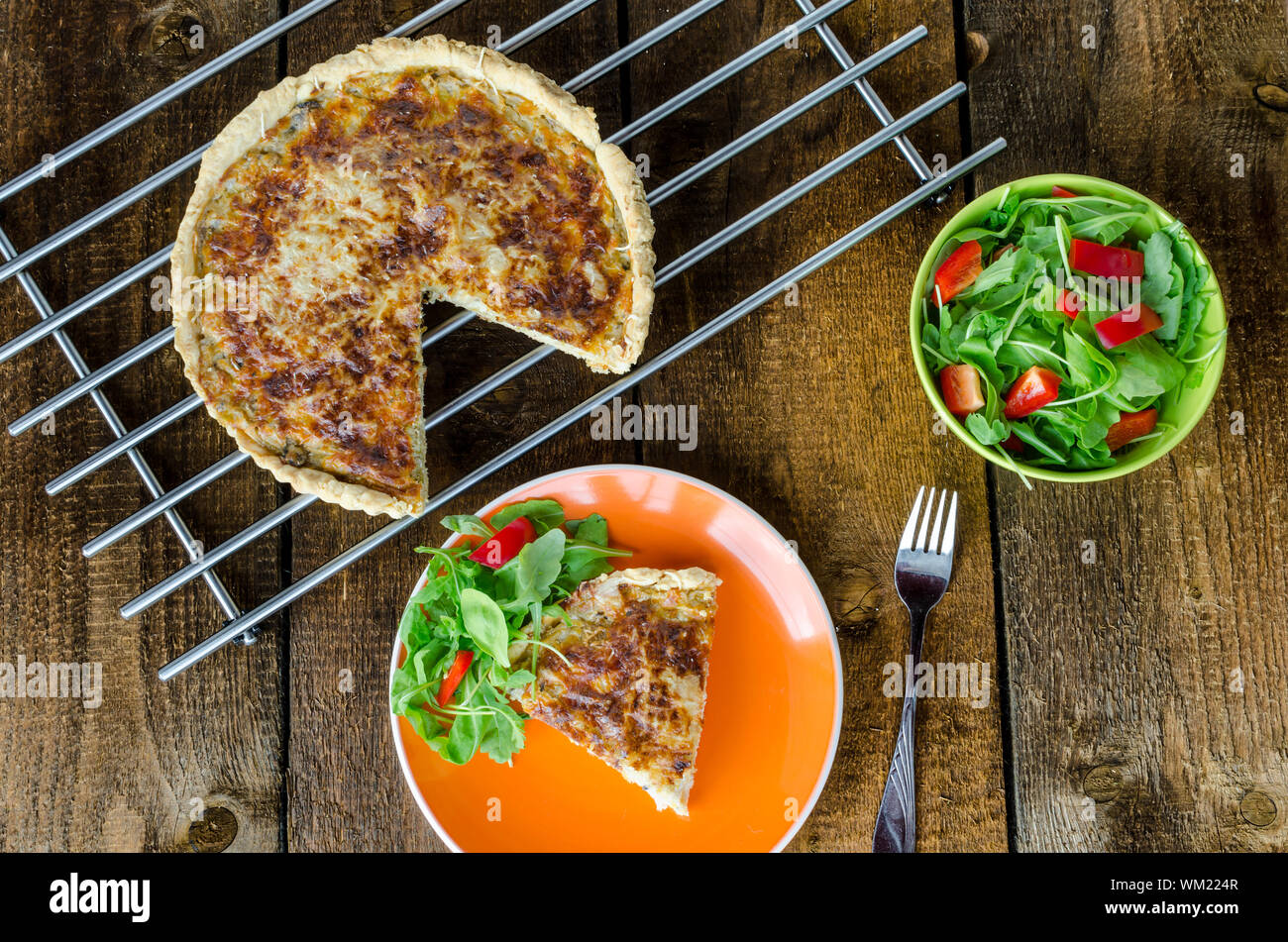 French quiche with cheese and salad paprica arugula Stock Photo Alamy